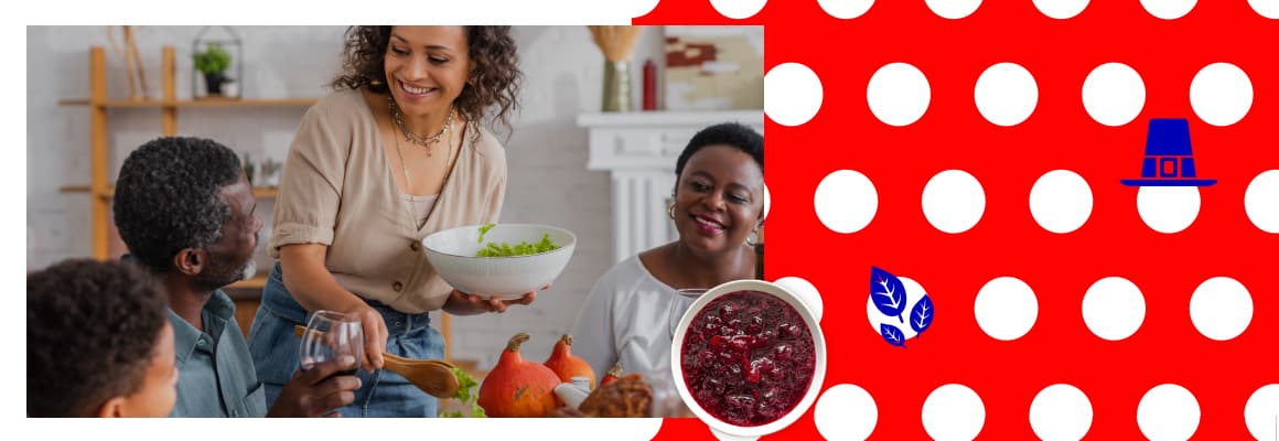 Mom dishing out salad to family seated at the table