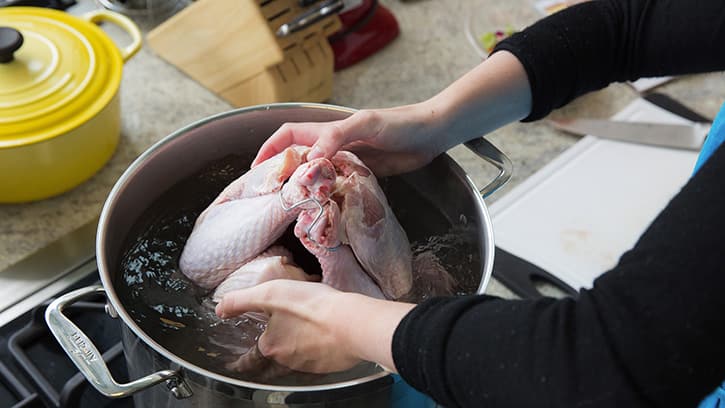 Turkey being lowered into wet brine
