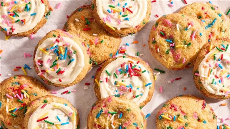 A group of cookies with frosting and sprinkles